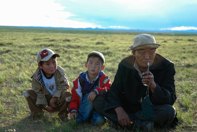 Photo of 2 boys with grandfather in Mongolia. Photo by Tengis Galamsh.com/s/photos/older-adults-with-children?utm_source=unsplash&utm_medium=referral&utm_content=creditCopyText">Unsplash